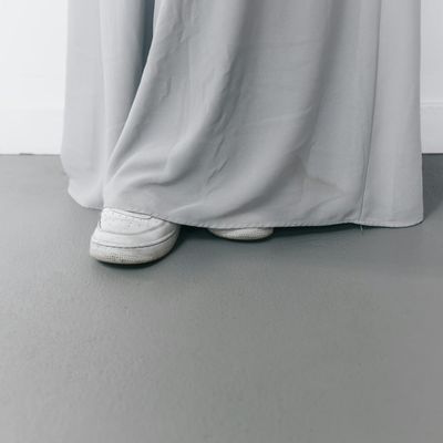 Feet in sneakers on a clean floor.